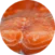 Close-up view of raw salmon slices, showing the orange flesh and white marbling in a circular frame.