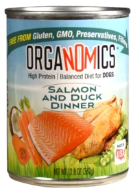 A case of 12 Organomics Variety Pack for Dogs (12.5 oz cans), featuring Salmon and Duck Dinner high-protein dog food that’s gluten-free, GMO-free, preservative-free, and showcases images of salmon, duck, carrots, peas, and coconut on the label.