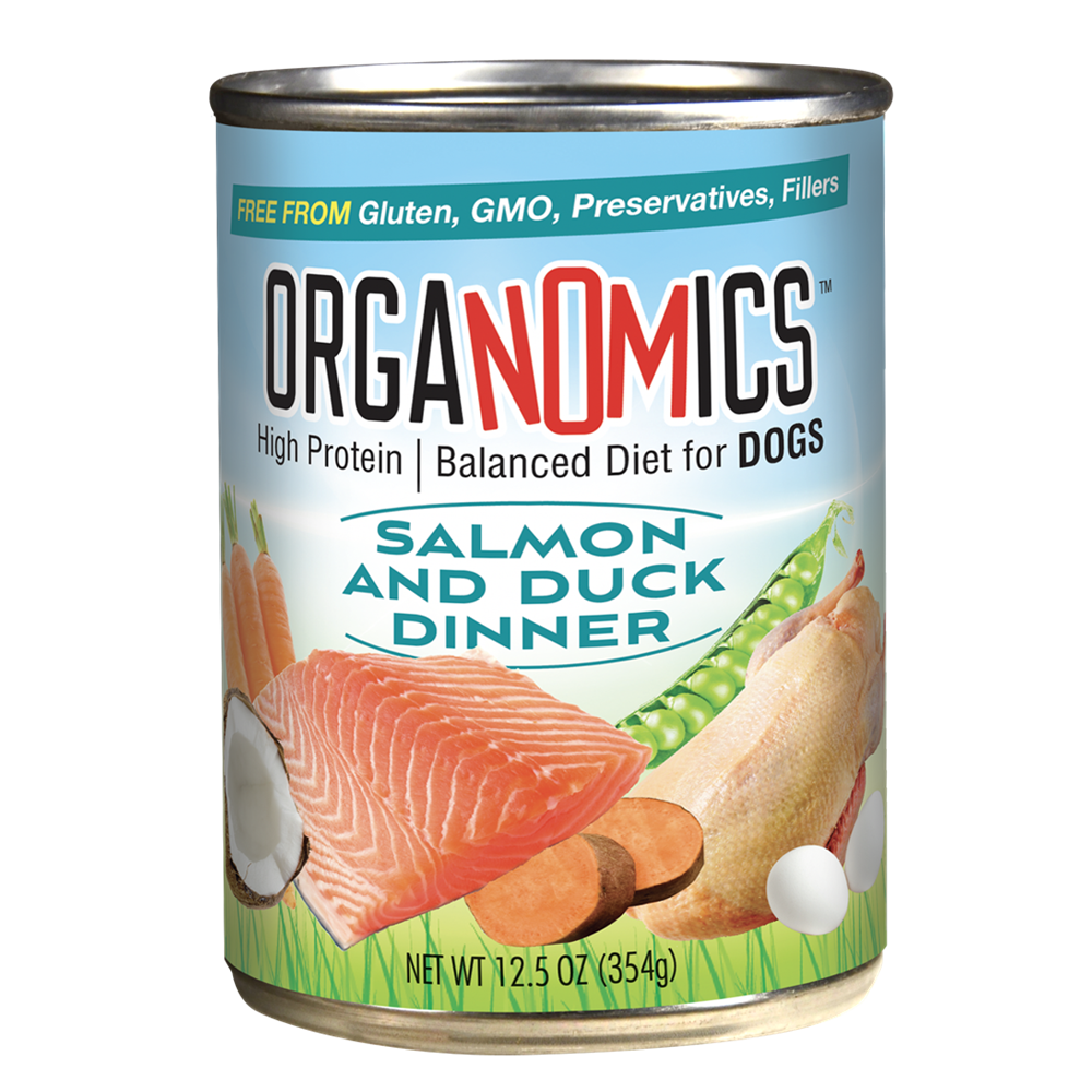 A can of OrgaNOMics Salmon and Duck Dinner for Dogs, featuring images of salmon, duck, peas, and coconut on the label, and emphasizing "High Protein" as well as being "Free from Gluten, GMO, and Preservatives.
